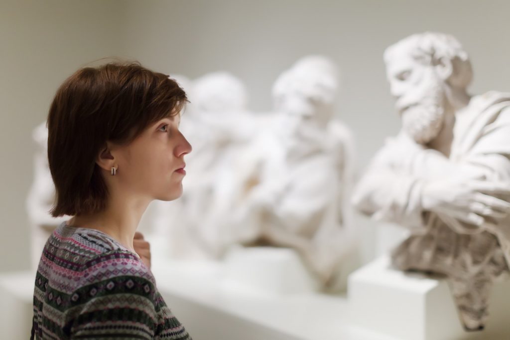 woman-looking-ancient-sculptures