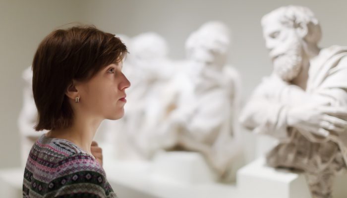 woman-looking-ancient-sculptures